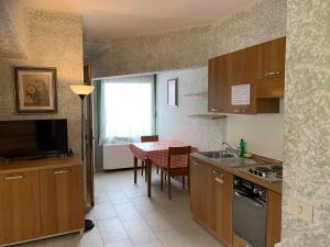 a kitchen with a table and a dining room at Gemini Studios in Florence