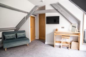 a living room with a couch and a desk in a attic at The Kingswood Hotel in Sidmouth