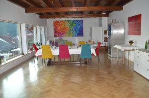 a dining room with a table and colorful chairs at Annettes Pfalz in Hinterweidenthal