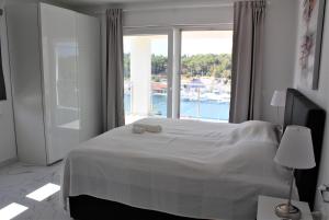 a bedroom with a large bed and a large window at Villa Lovisa - 4 star villa with pool and amazing sea view in Milna +41 photos