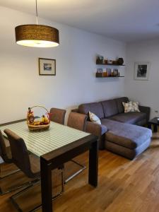 a living room with a table and a couch at Seaview Apartment in Bar