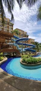 a pool with a water slide in front of a building at Gold Coast Morib Resort in Banting