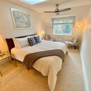 a bedroom with a large bed and a window at Otter's Pond Bed and Breakfast in Eastsound