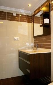 a bathroom with a sink and a mirror at Apartamentos Barrosa II in Portonovo