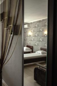 a room with two beds and a mirror at Cocos Hotel in Rostov on Don