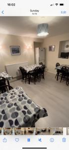 a dining room with tables and chairs and a checkerboard at Holburn Guesthouse in Aberdeen