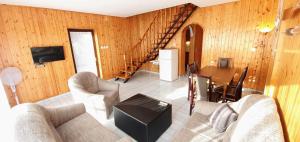 a living room with a couch and a table at Varga Gardens Balatonmáriafürdő in Balatonmáriafürdő