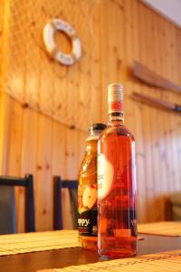 a bottle of honey sitting on a wooden table at Varga Gardens Balatonmáriafürdő in Balatonmáriafürdő