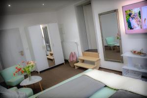 a living room with a couch and a mirror at Villa Prestige in Zeitz