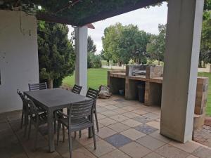 a table and chairs on a patio at Kleine Kaap - Selfsorg in Orania