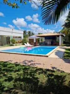 a swimming pool in front of a house at Terra Bahia in Aracaju