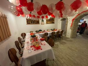 a long table with red and white balloons in a room at Apartmán Alva 3 in Mikulov