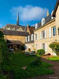 a group of buildings with a church in the background at Les Tourterelles in Vendôme