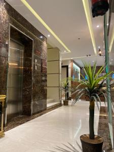 a hallway with a potted plant in a building at السامية الفندقية in Sharurah