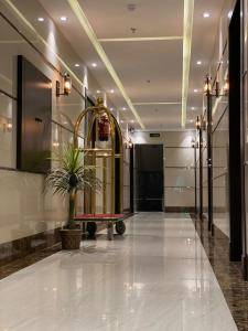 a hallway with a potted plant in a building at شقق السامية للشقق المخدومة in Sharurah +21 photos