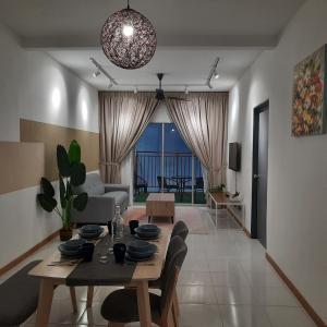 a living room with a table and a couch at V Cozy Homestays in Brinchang