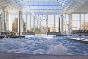 a large swimming pool with water in a building at Grand Hotel des Iles Borromées & SPA in Stresa