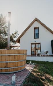 a white house with a wooden fence in front of it at Málna Major in Mályinka