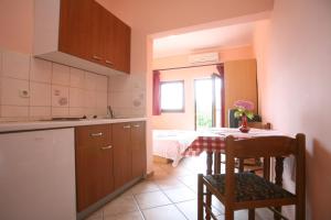 a kitchen with a table and a dining room at Apartments Neda - Poreč South in Poreč