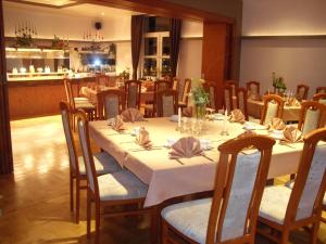 a dining room with a long table and chairs at Hotel Cappuccino in Elze
