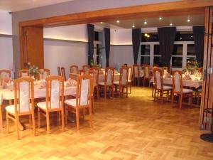a dining room with tables and chairs in it at Hotel Cappuccino in Elze