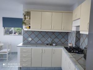 a kitchen with white cabinets and a sink at Apartamento Puerto Estaca 1 in Valverde +26 photos