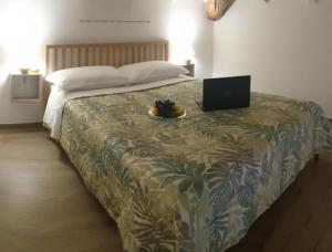 a bedroom with a bed with a laptop on it at B&B La casa di Ale in Verona
