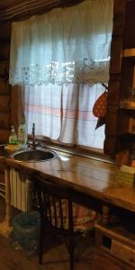 a kitchen counter with a sink and a window at House Liteyschika Nikulicheva with Banya in Suzdal