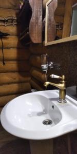 a bathroom with a white sink and a mirror at House Liteyschika Nikulicheva with Banya in Suzdal