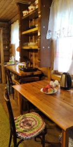 a wooden table with a plate of fruit on it at House Liteyschika Nikulicheva with Banya in Suzdal
