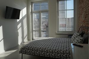 Ένα ή περισσότερα κρεβάτια σε δωμάτιο στο Apartament Gliwice Centrum Witkiewicza II