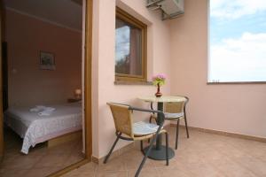 a room with a table and a bed and a mirror at Apartments Neda - Poreč South in Poreč