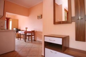 a kitchen and dining room with a table at Apartments Neda - Poreč South in Poreč
