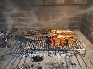 a bunch of food cooking on a grill at Dubis House in Zadar