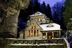 an old stone house with snow on it at Stara Plynarna in Hřensko