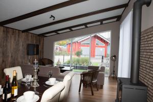 a living room with a table and chairs and a fireplace at Welgedacht in Sint Annaland