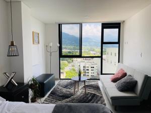 亚美尼亚Hermoso Apartaestudio con excelente ubicación的带沙发和大窗户的客厅