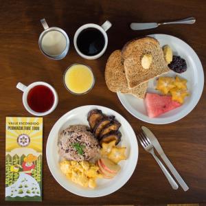 a table with two plates of breakfast foods and coffee at Valle Escondido Nature Reserve Hotel & Farm in Monteverde Costa Rica