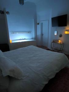 a bedroom with a white bed and a window at Il Sitarein in Bologna