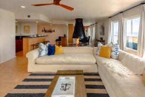 a living room with two white couches and a table at Beachwalk Villas in Carlsbad