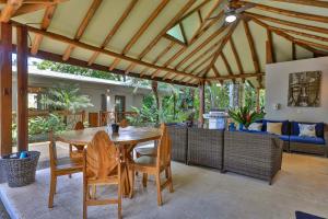 a dining room with a wooden table and chairs at Casa de Paz- Portasol Vacation Rentals in Matapalo