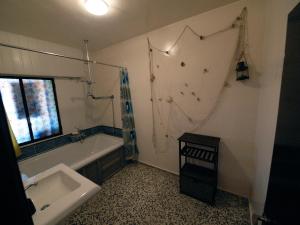 a bathroom with a tub and a sink and a shower at La Tierra Verde COTTAGE in Alcuéscar +11 photos