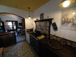 a kitchen with a sink and a counter top at La Tierra Verde COTTAGE in Alcuéscar