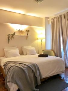 a bedroom with a large bed with white sheets at Port Dickson Glory Beach Resort Apartment 5pax 3BR in Port Dickson