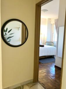 a mirror on a wall in a room at Port Dickson Glory Beach Resort Apartment 5pax 3BR in Port Dickson