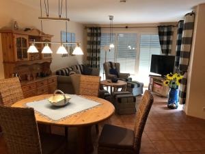 a kitchen and living room with a table and chairs at Nele 02 in Zingst