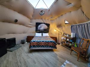 a bedroom in a tent with a bed in it at The Kosmic Tortoise in Twentynine Palms
