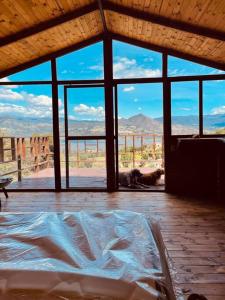a bedroom with a bed with a view of the desert at La Leopolda in Guatavita