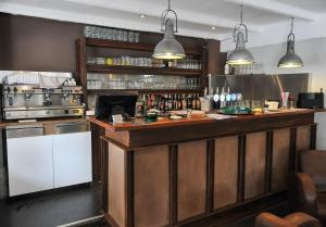 a bar in a restaurant with two pendant lights at Ô Villagio Hôtel in Villeneuve-Loubet