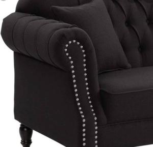 a black couch with pearl buttons on it at Chez Vous French Farmhouse Villa 4 in Pokolbin